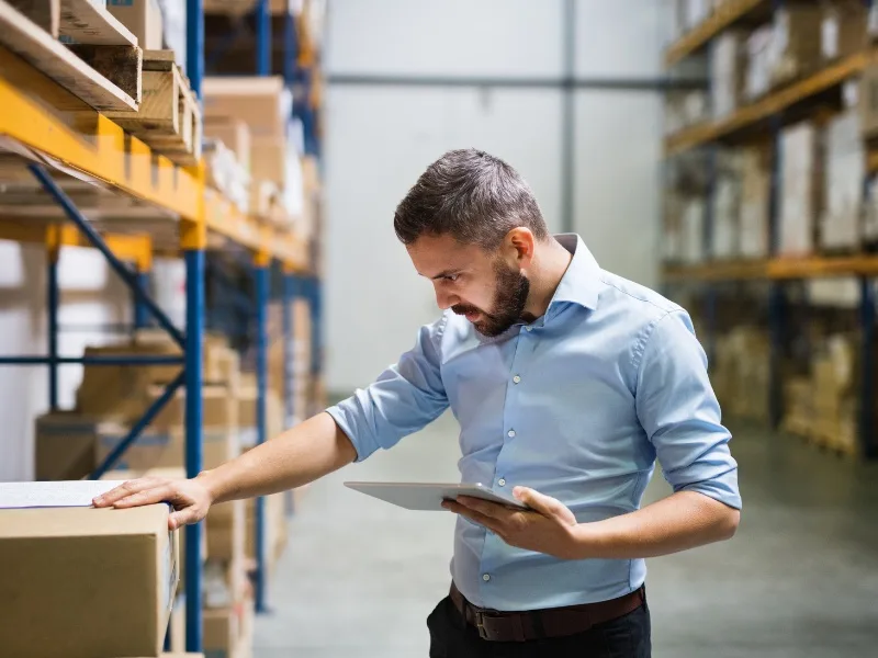  Warehouse worker taking stock take in warehouse facility for corporate store