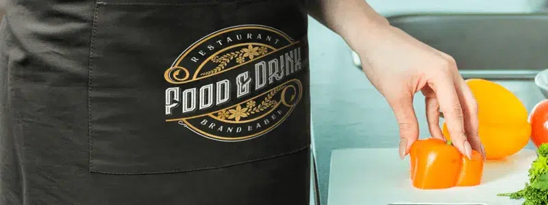 A custom-branded apron featuring a logo, perfect for hospitality and promotional use.