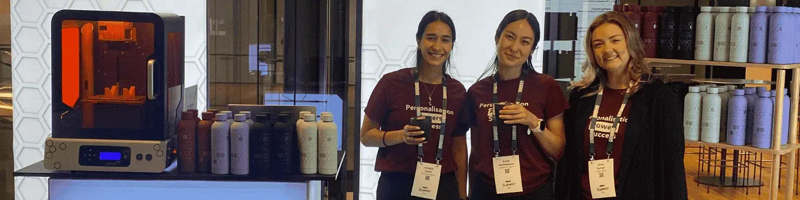 Natalie Farah and Activation team at Generate Summit 2025 laser engraving branded drinkware.