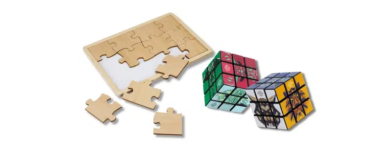 Wooden puzzle pieces and branded Rubik’s cube