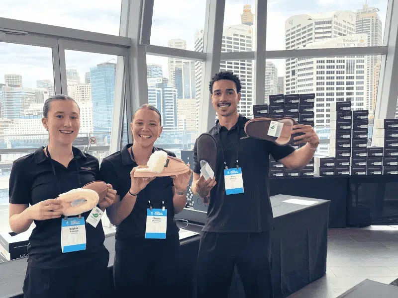 Honeycomb activation team presenting personalised UGG boots at Young Presidents Organisation event in Melbourne