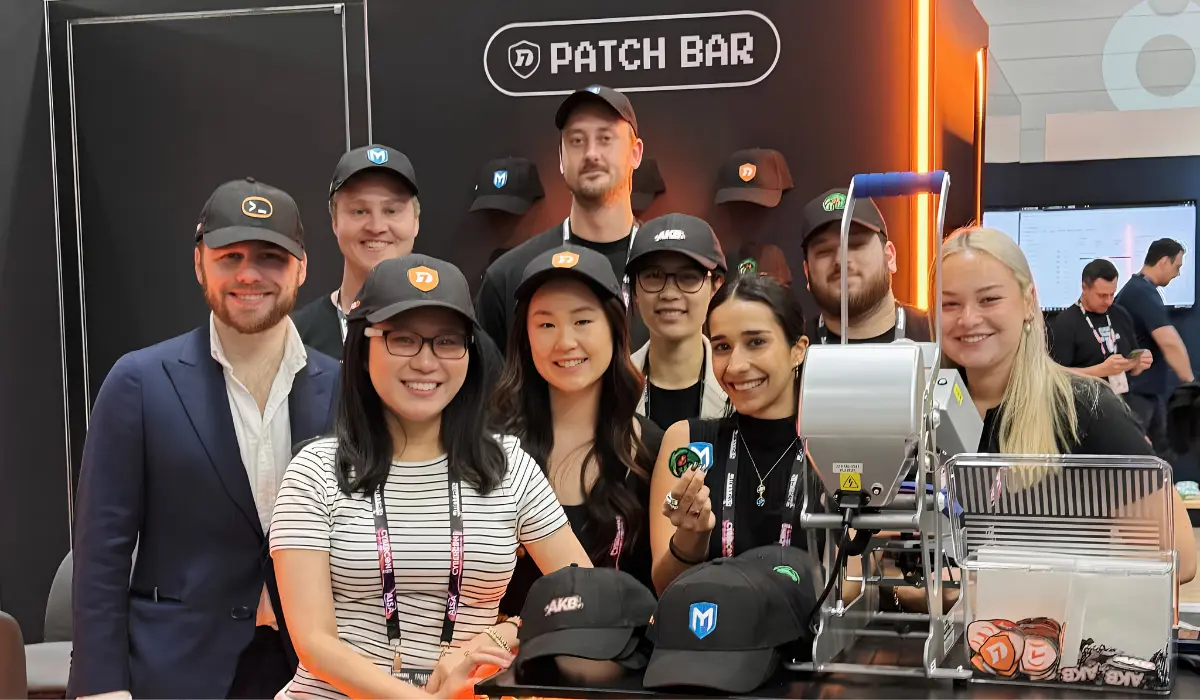 The Honeycomb team smiling together at a "Patch Bar" brand activation stand