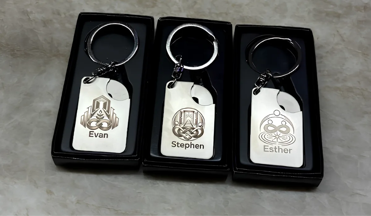 Three Charter Hall trolley keyrings engraved with unique AI-generated emblems and the guest names Evan, Stephen and Esther