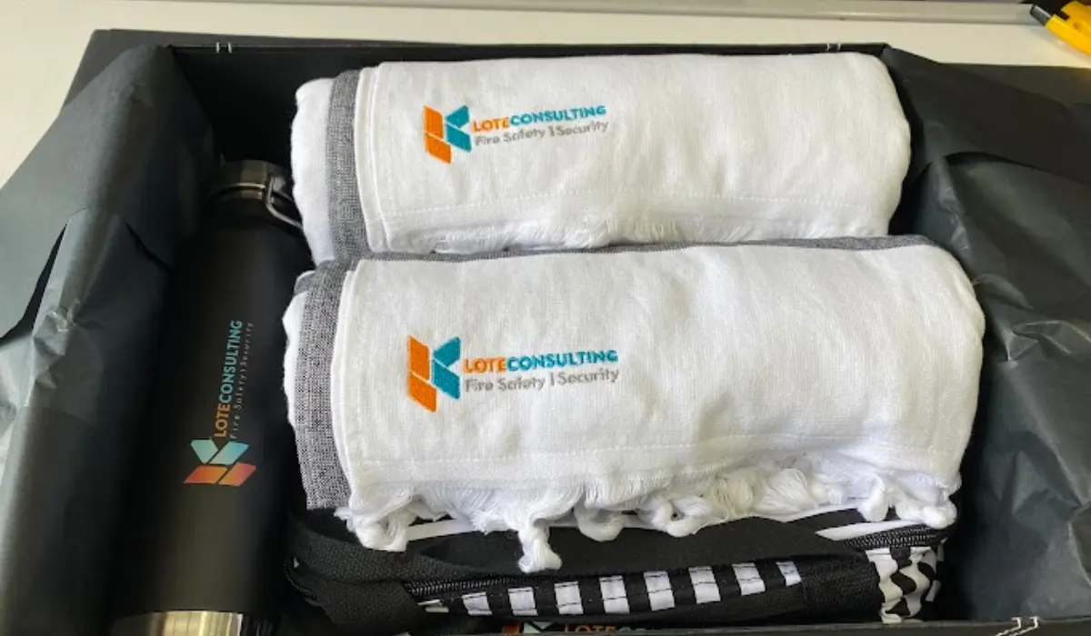 logo towels and a drink bottle in a black box